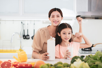 mother and child drinking milk at the kitchen