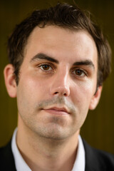 Fototapeta premium Portrait of businessman in suit against bamboo wall outdoors