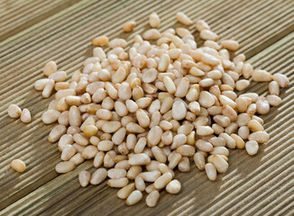 Pine nuts on a wooden surface. Natural background. High quality photo