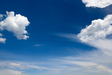 Naklejka na ściany i meble White clouds against background of bright blue sky.