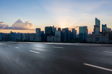 road with hangzhou skyline at sunset