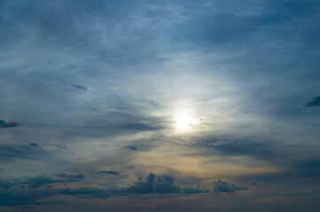 Sun peeking through the clouds at sunset