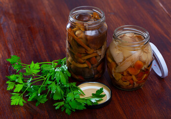 Close-up of tasty canned assorted mushrooms at glass jar