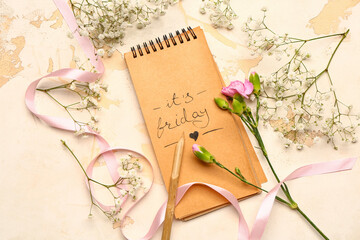 Notebook with text IT'S FRIDAY on white background