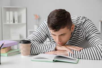 Tired student sleeping at table