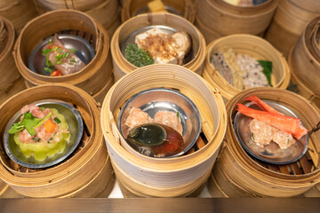 Variety of dim sum in bamboo basket. Chinese breakfast style in Southern of Thailand.