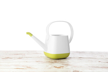 Watering can on table against white background