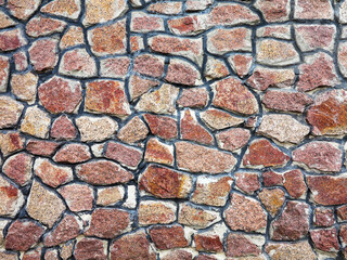 Stone wall background. Background of stone wall of boulders and pebbles