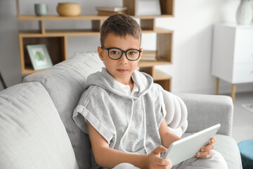 Cute little boy with tablet computer at home