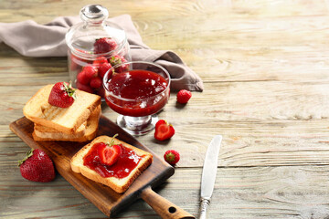 Bread with tasty strawberry jam on table