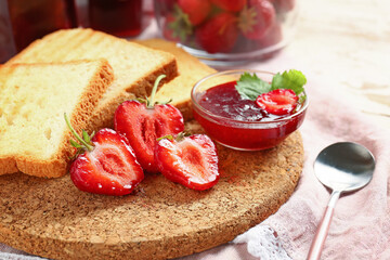 Bread with tasty strawberry jam on table