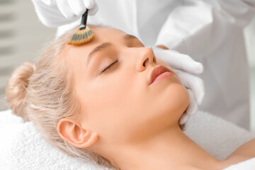 Obraz na płótnie Canvas Young woman undergoing treatment in beauty salon