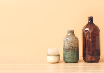 Beautiful vases on table against color background