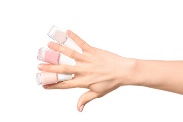 Hand with nail polishes on white background