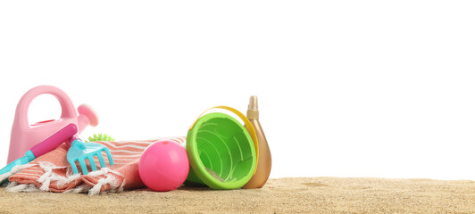 Set of beach accessories for children on sand against white background