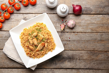 Plate with tasty pilaf on table