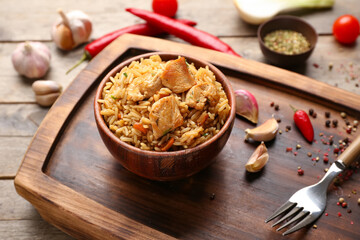 Bowl with tasty pilaf on table