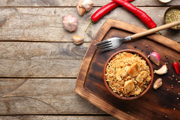 Bowl with tasty pilaf on table