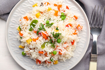 Plate with tasty pilaf on table