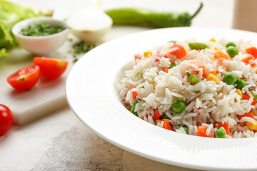 Plate with tasty pilaf on table, closeup
