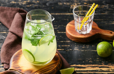 Jug of fresh mojito on table