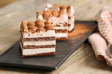Plate with tasty tiramisu on table