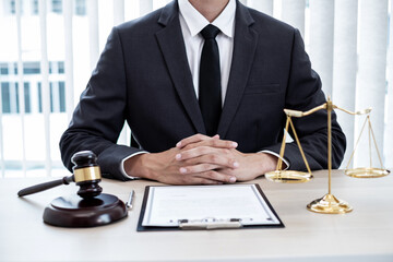 Professional male lawyers work at a law office There are scales, Scales of justice, judges gavel, and litigation documents. Concepts of law and justice
