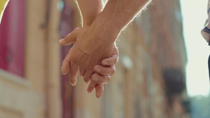 At sunlight close up young hands gay couple stroking and holding stand homosexual romance relationship lgbt support happiness outdoors dating slow motion - Powered by Adobe
