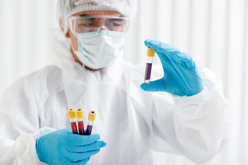 Researchers test blood samples in the laboratory. Researchers are inventing vaccines to treat COVID-19 virus.