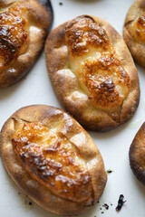 Traditional Finnish Karelian pasties on white marble background