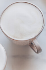Top view of coffe Cappuccino cup on white marble background with copy space