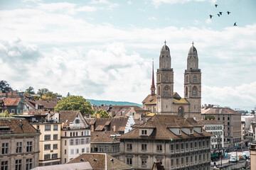 Fototapeta na wymiar Beautiful views of Zurich old town and Grossmunster from Linderhof hill. Switzerland