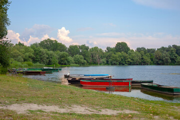 Old wooden fishing boats on a pond. Traditional small fishing boats on river bank in northern part of Serbia.