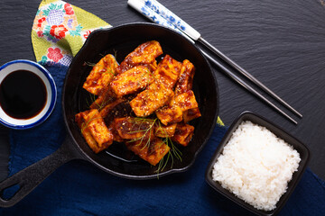 Healthy Asian food concept Homemade stirs fried spicy chili sauce, organic tofu in skillet iron pan with copy space