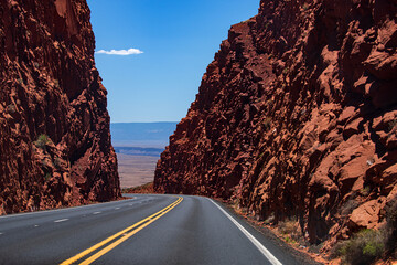 Road against the high orange rocks. Summer highway. American road trip.