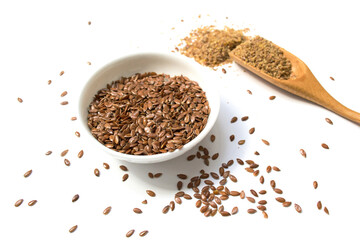 Flax seeds. Flaxseed powder in a wooden spoon. Standing on a white background.