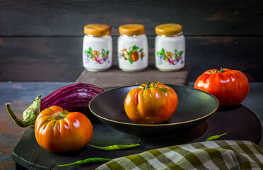 Preparation with vegetables on dark ground in the kitchen