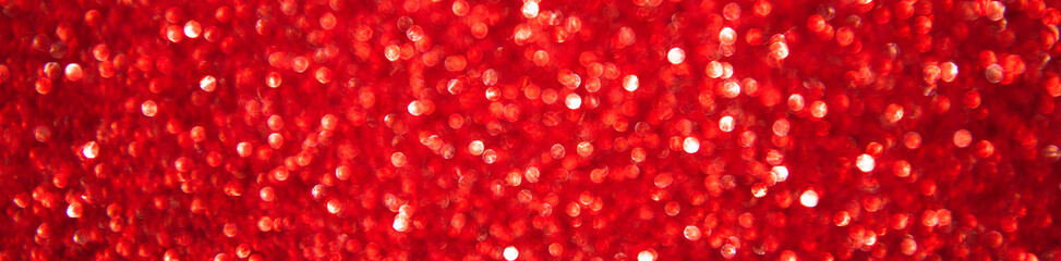 Abstract glitter christmas red background. Shimmer bright background with bokeh defocused red...