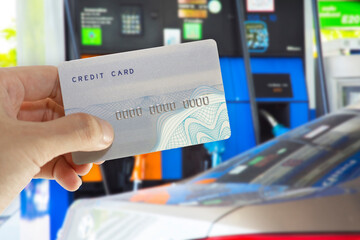 Credit card with mobile phone to make a payment for refueling car on gas station
