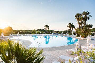 Water Pool with Sunbeds, Umbrellas and Palms. Luxury Panoramic View.