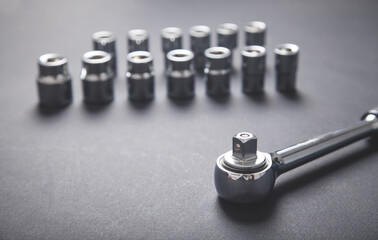 Different sizes wrenches on the black background.