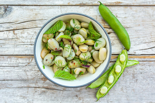 A healthy rich protein salad made from broad beans and fresh herbs. Vegetarian food.