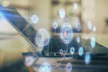Double exposure of table with computer on background and data theme hologram. Data technology concept.