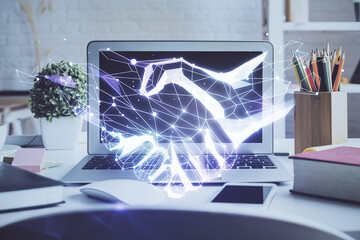 Desktop computer background in office and handshake hologram drawing. Double exposure. Pertnership...