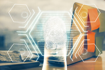 Computer on desktop in office with finger print drawing. Double exposure. Concept of business data security.