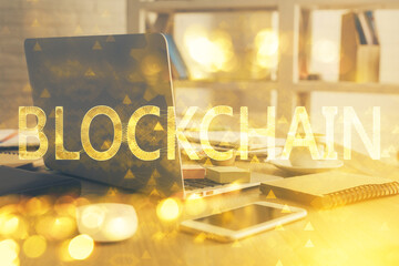 Multi exposure of blockchain theme hologram and table with computer background. Concept of bitcoin crypto currency.