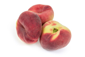 Three flat peaches on a white background