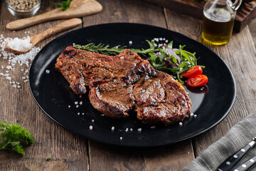 Juicy beef steak on a black plate