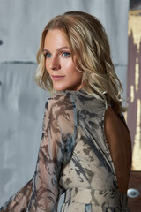 Fototapeta premium Beautiful blonde woman in evening dress. Beauty portrait of an ideal girl, clean delicate skin of the face and body