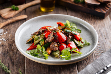 Warm salad with beef and vegetables on a plate